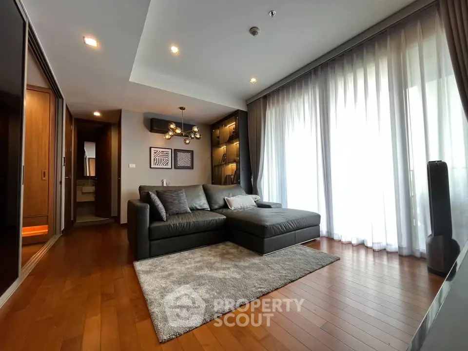 Spacious modern living room with elegant decor and large windows for natural light.