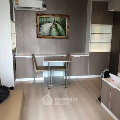 Modern living room with elegant decor and stylish furniture, featuring a captivating peacock painting.