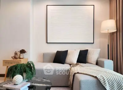 Modern living room with stylish sofa, elegant decor, and ambient lighting for a cozy atmosphere.