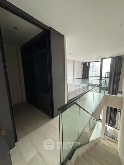 Modern duplex apartment with glass railing and city view