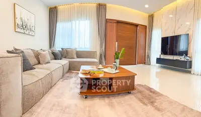Spacious modern living room with elegant decor and large TV setup