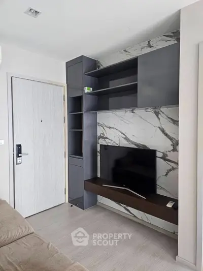 Modern living room with sleek TV unit and marble accent wall