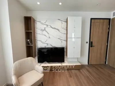Modern living room with stylish TV setup and elegant marble accent wall