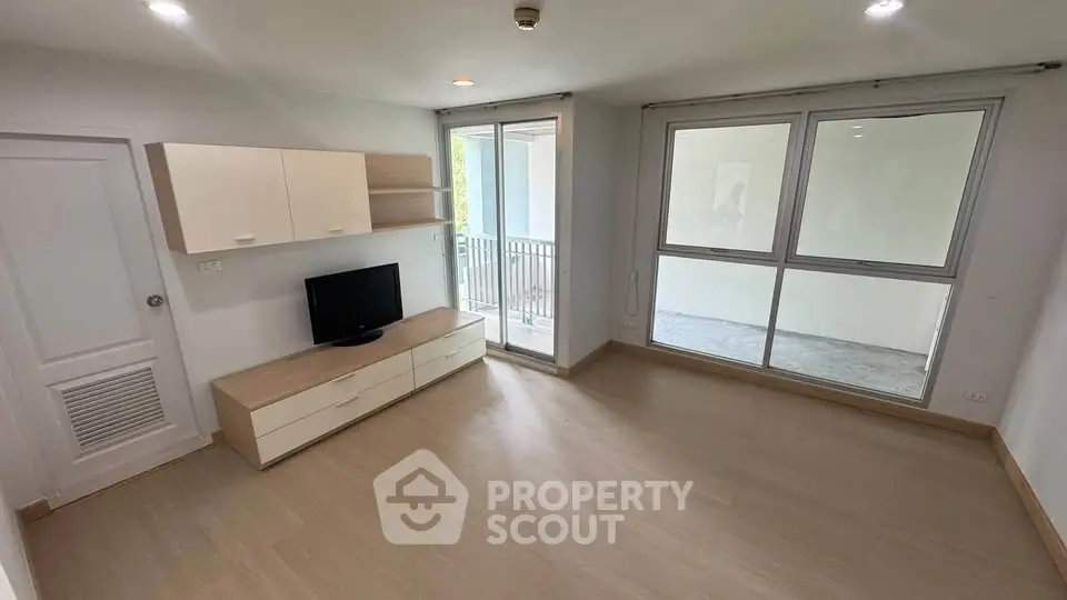 Spacious living room with modern design and large windows for natural light.