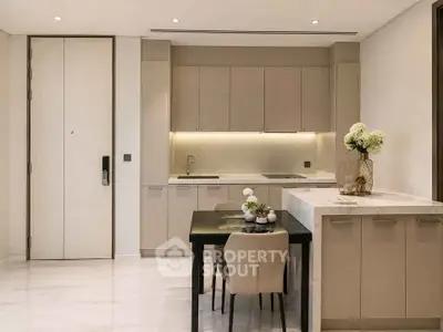 Elegant modern kitchen with sleek cabinetry and cozy dining area, perfect for urban living.