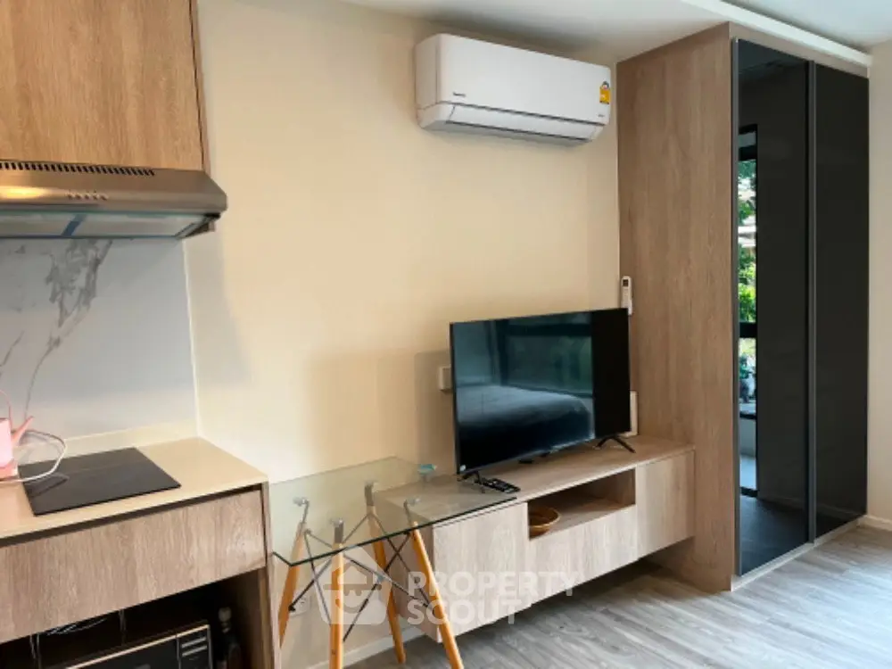 Modern living room with sleek furniture and air conditioning in a stylish apartment.