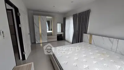 Spacious modern bedroom with sleek design and ample natural light