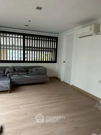 Modern living room with wooden flooring and natural light