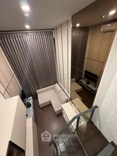 Modern loft-style living room with sleek design and cozy seating area