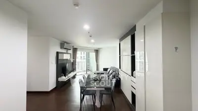 Spacious modern living room with dining area and balcony view