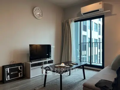Modern living room with balcony view, featuring sleek furniture and natural light.