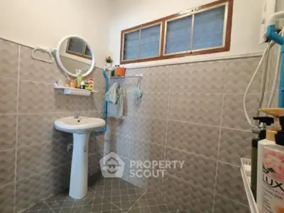 Modern bathroom with pedestal sink and geometric tile design