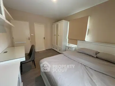 Cozy bedroom with modern furnishings and ample storage space, perfect for a restful retreat.