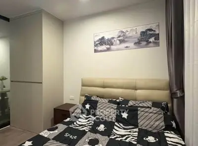 Cozy bedroom with modern decor and stylish bedding in a contemporary apartment.