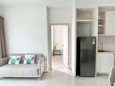 Modern apartment interior with cozy living room and sleek kitchen design.