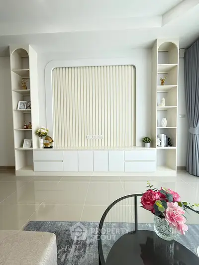 Elegant living room with modern built-in shelves and stylish decor