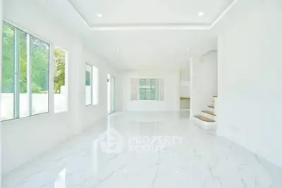 Spacious modern living room with large windows and glossy marble floors