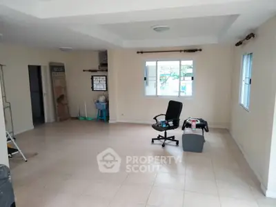 Spacious unfurnished room with office chair and large windows