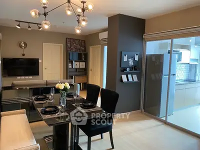 Modern dining area with elegant lighting and open kitchen in stylish apartment