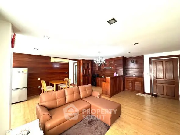 Spacious open-plan living room with modern kitchen and wooden accents