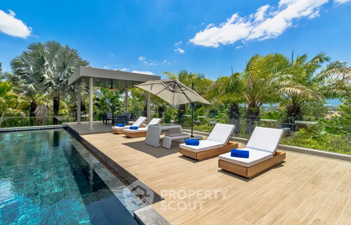 Luxurious poolside oasis with sun loungers and tropical landscaping