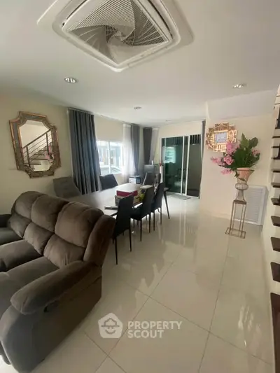 Spacious living room with modern decor and elegant dining area