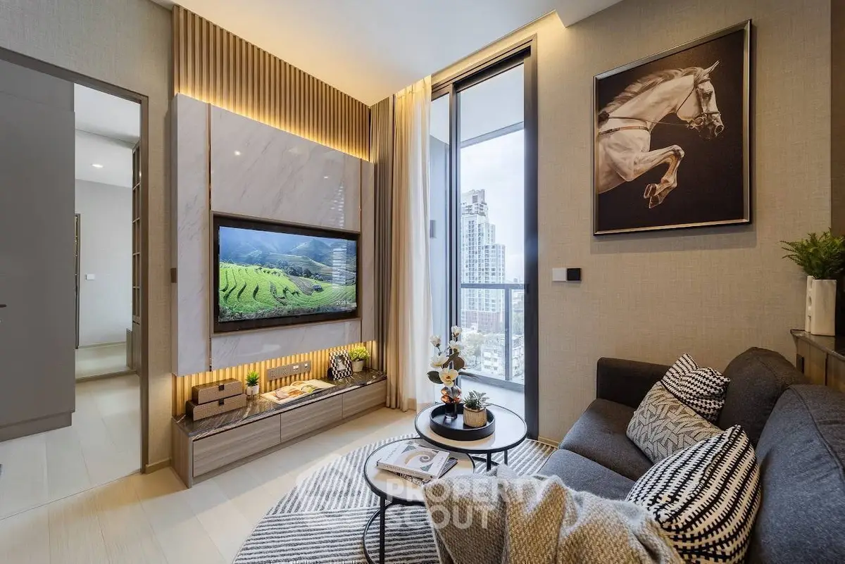 Modern living room with city view, stylish decor, and cozy seating area.