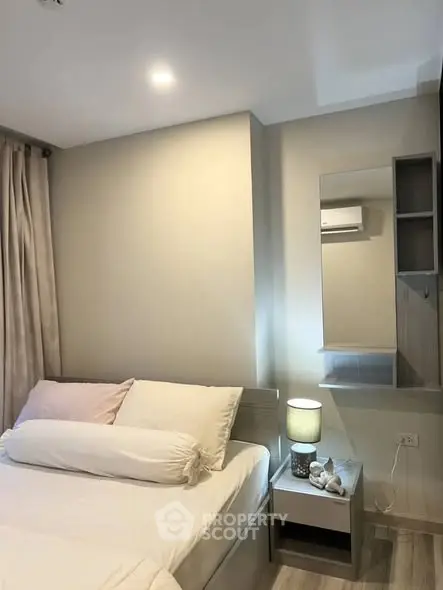 Cozy bedroom with modern decor and soft lighting, perfect for relaxation and comfort.