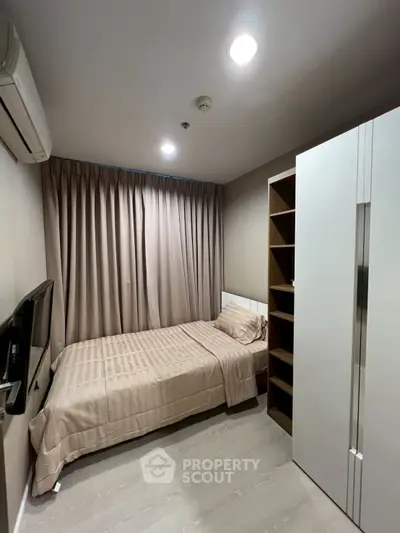 Cozy bedroom with modern furnishings and ample storage space