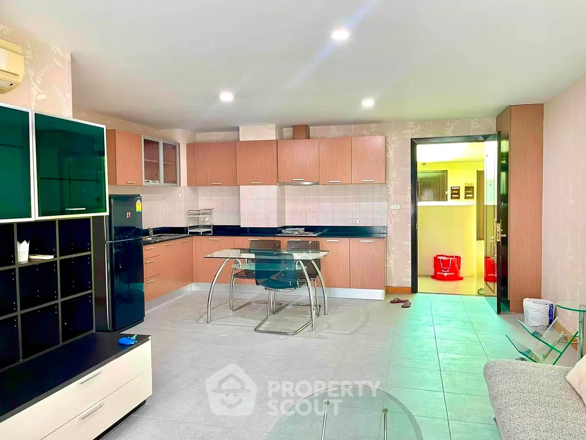 Spacious modern kitchen with open layout and sleek cabinetry in a contemporary apartment.