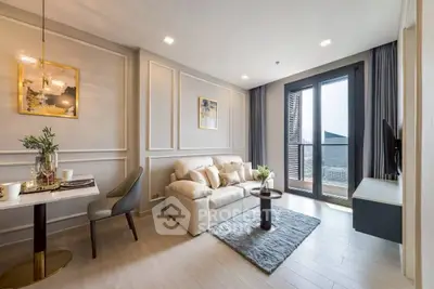 Elegant living room with modern decor and balcony view in luxury apartment.