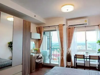Charming bedroom with balcony view and modern decor in high-rise apartment