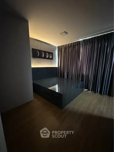 Modern bedroom with sleek design, featuring a stylish bed and elegant curtains, perfect for a cozy retreat.