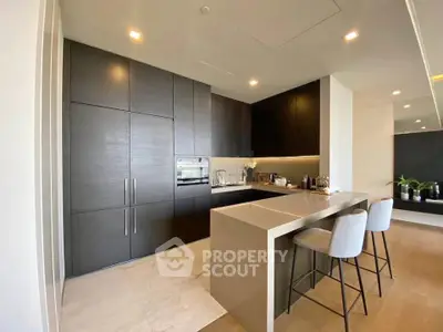Modern kitchen with sleek cabinetry and breakfast bar in luxury apartment