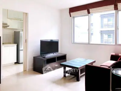 Bright living room with modern furniture and large window in a stylish apartment.