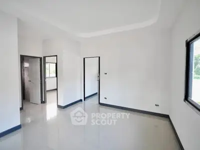 Spacious empty room with large windows and modern design