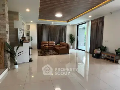 Spacious modern living room with elegant decor and large windows for natural light.