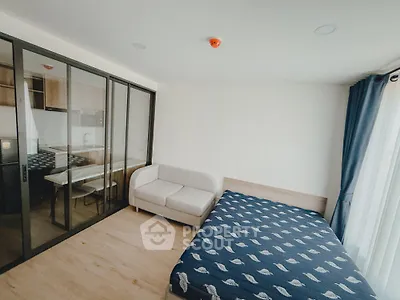 Modern bedroom with glass partition and cozy furnishings in a stylish apartment
