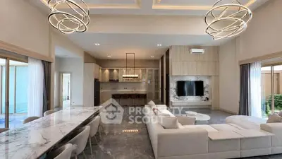 Luxurious open-plan living room with modern decor and elegant lighting