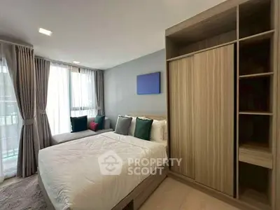 Modern bedroom with stylish decor and ample natural light