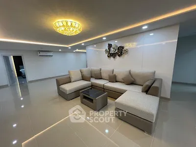 Spacious modern living room with elegant lighting and plush sectional sofa.