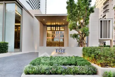 Luxurious modern building entrance with lush greenery at The Esse Asoke.