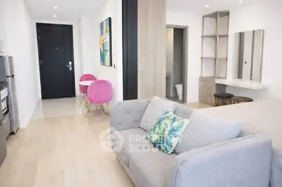 Modern open-plan living room with stylish decor and vibrant accents in a contemporary apartment.