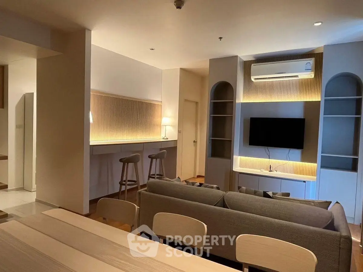 Modern living room with stylish decor and ambient lighting