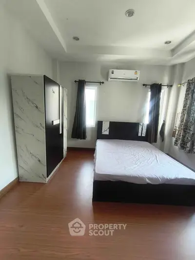 Spacious bedroom with modern decor and natural light