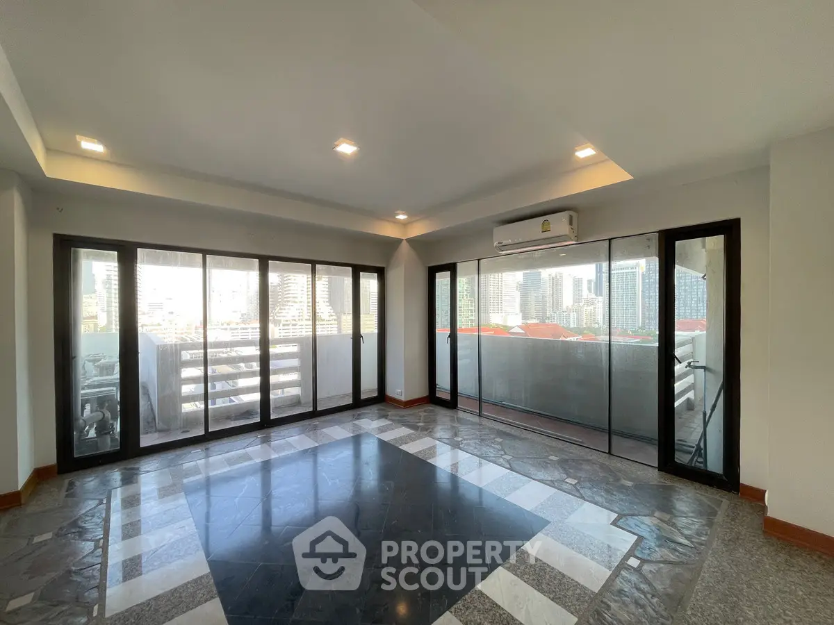 Spacious corner unit with floor-to-ceiling windows offering stunning city views and abundant natural light.