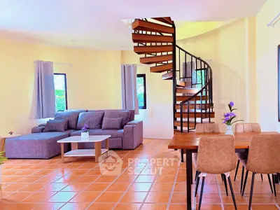Spacious living room with spiral staircase and modern decor