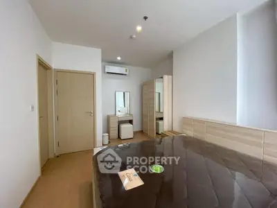 Modern bedroom with wooden furniture and air conditioning