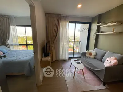 Charming modern apartment with cozy living room and bedroom, featuring large windows and a small balcony.