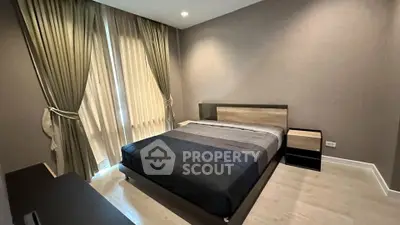 Modern bedroom with elegant curtains and stylish furniture in a cozy apartment.